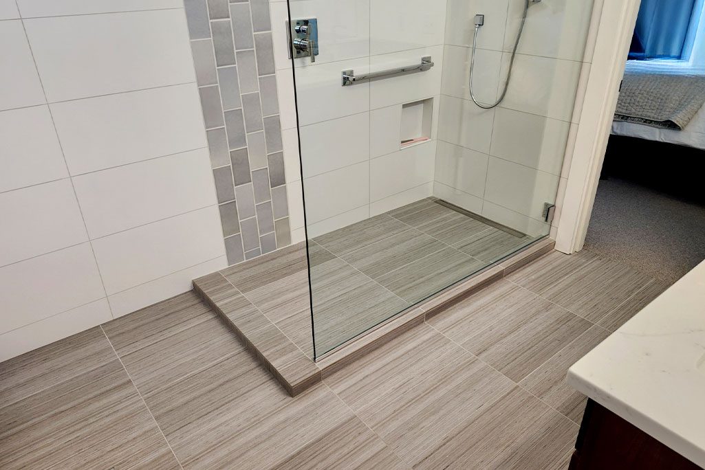 Bathroom Remodel with Floating Glass and Gently Sloped Drain